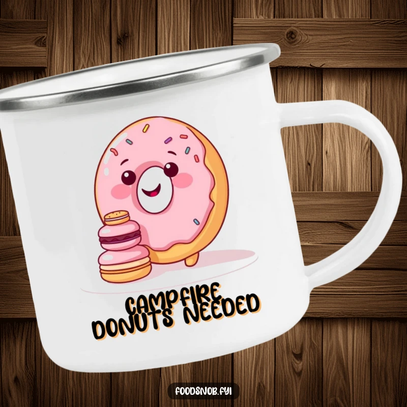 Funny camping mug with a smiling donut character with sprinkles attempting to stack miniature macarons, perfect for sweet outdoor enjoyment.