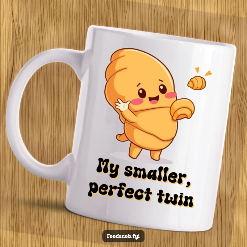 Funny mug showing a cute, smiling croissant character dramatically pointing at a smaller, golden croissant, expressing pure pastry joy and humor.