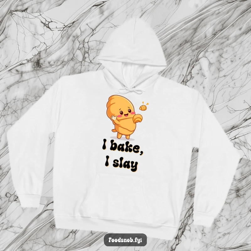 Funny hoodie with a cute, smiling croissant character dramatically gesturing to a tiny golden croissant, radiating warmth and hilarious pastry appreciation.
