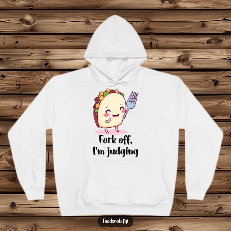 Funny taco hoodie with a smiling taco on tiny legs, nose-critiquing a small fork, perfect warm and humorous clothing gift.